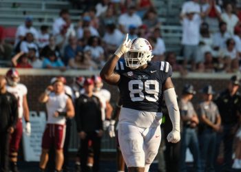JJ Pegues throws up the fins up sign during a football game against Troy; horizontal image