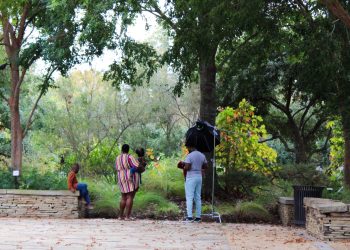 A family takes pictures at the Art Garden