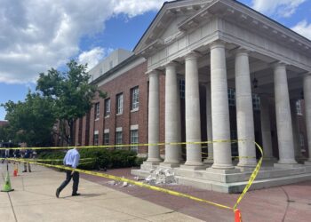Section of concrete pediment falls onto Business Row at Holman Hall