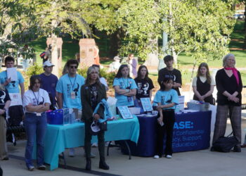 Alt text: "Take Back the Night" attendees listening to Bonny Shade on the Union Plaza
